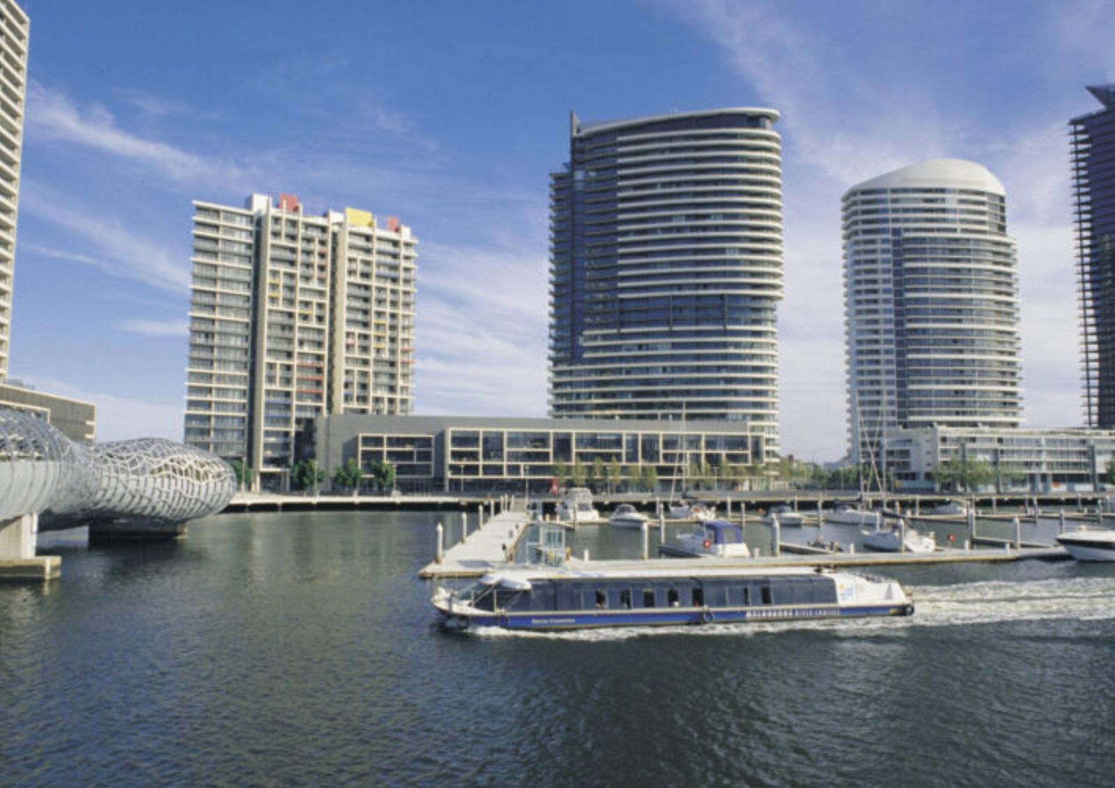 The ferry passing the Webb Bridge and apartment towers at Docklands