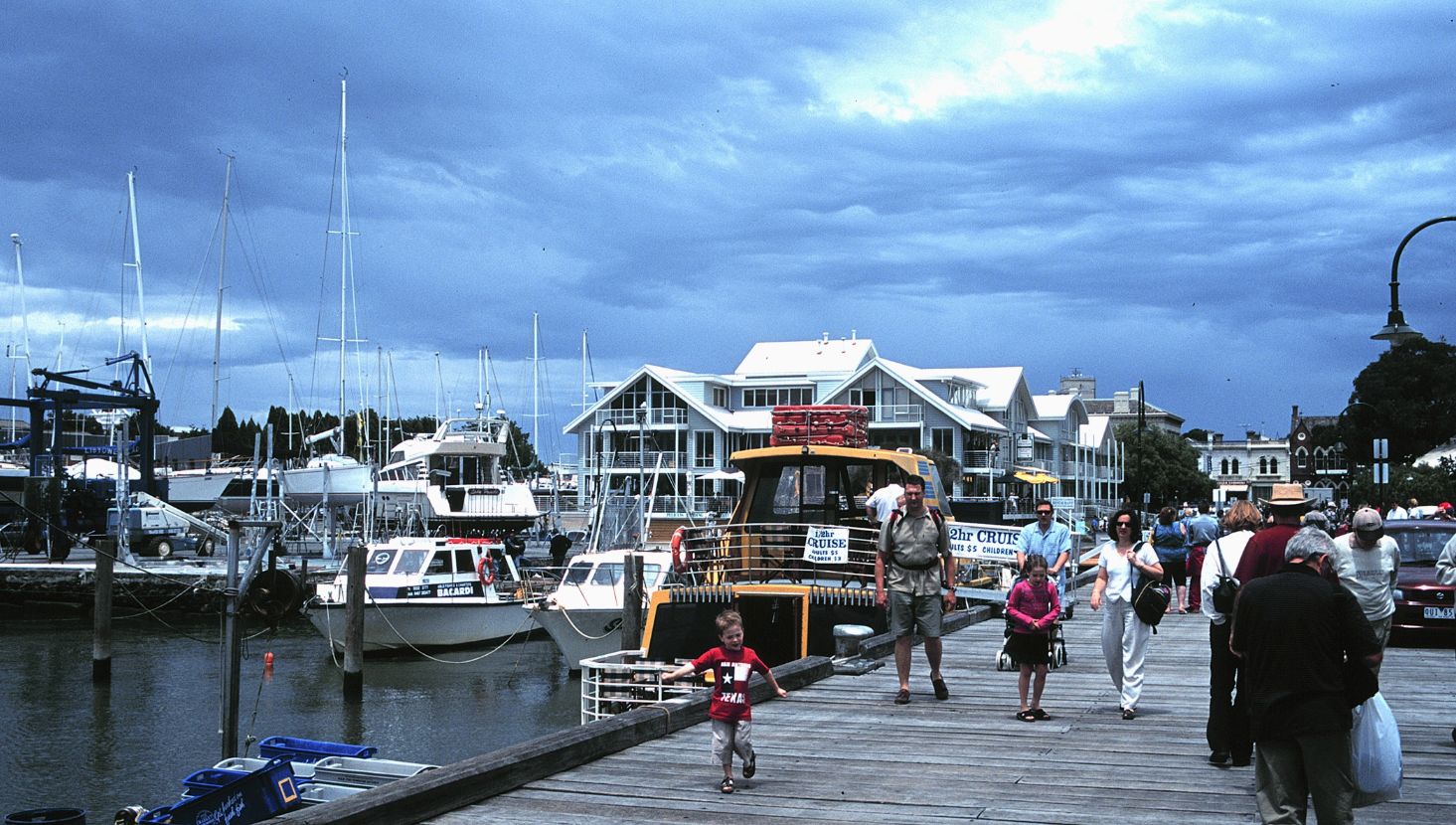 Families walking along the boardwalk at Williamstown harbour