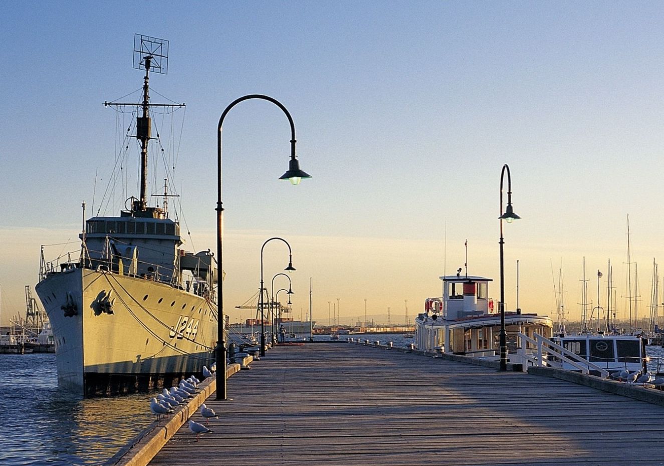 HMAS Castlemaine museum ship moored at Gem Pier at dusk